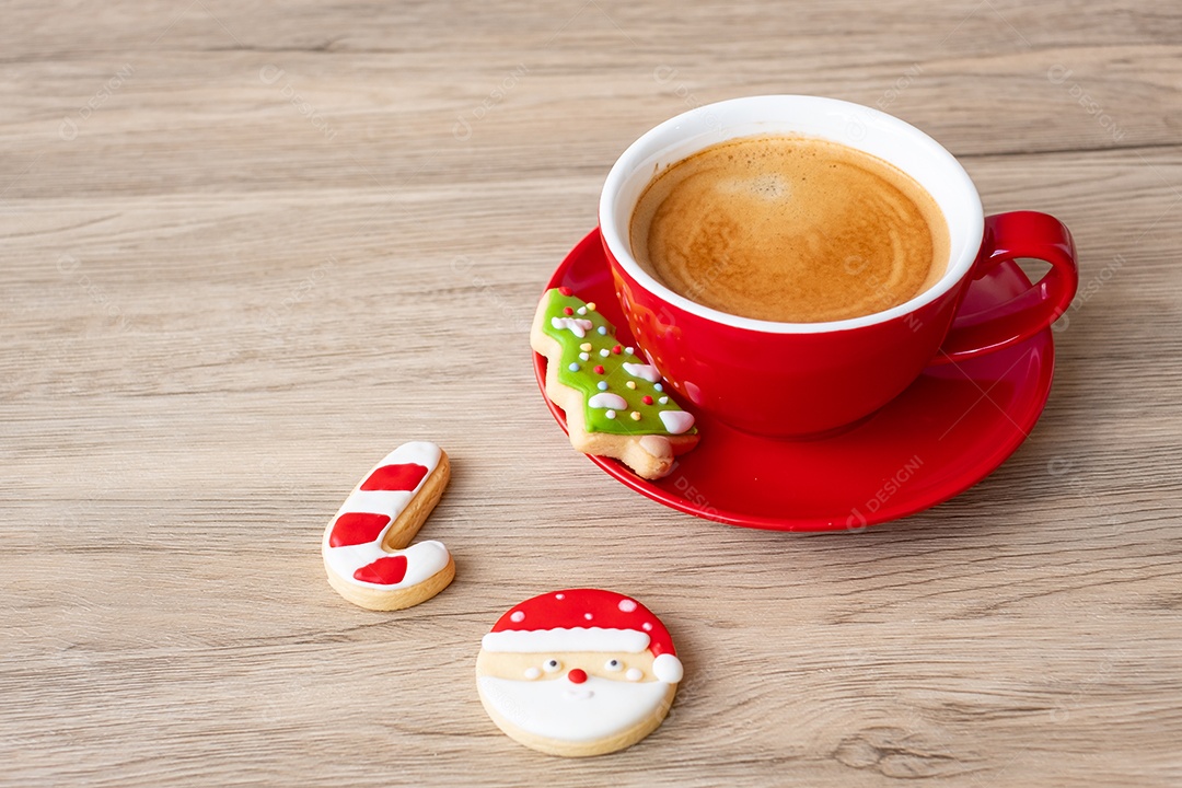 Feliz Natal com biscoitos caseiros e xícara de café na aba de madeira.