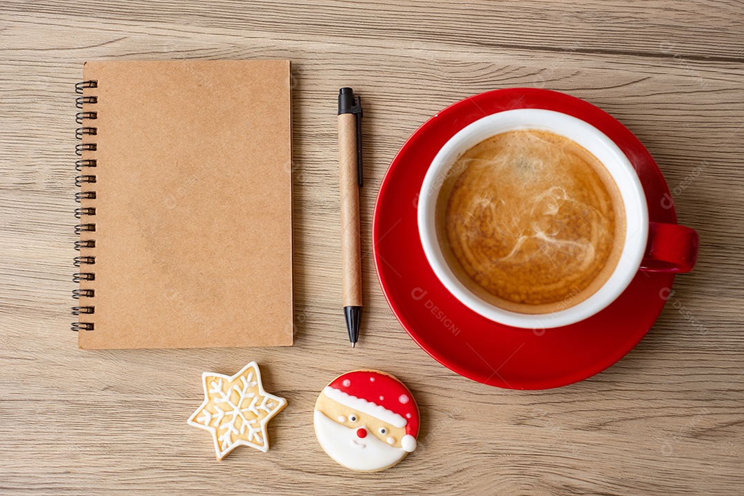 Blank notebook, black coffee cup, Christmas cookies and pen.