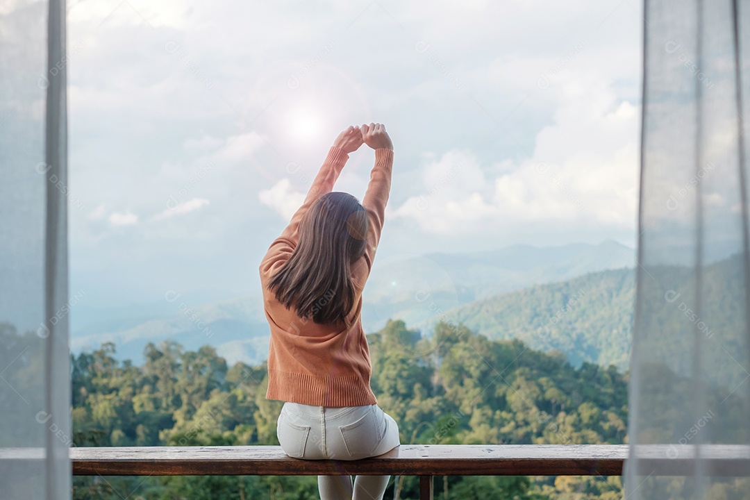 Happy woman relaxing and looking at mountain view in countryside.