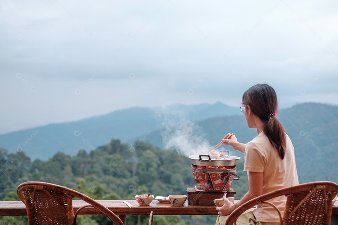 Mulher grelha Carne de porco ou carne com legumes e sopa na panela quente.