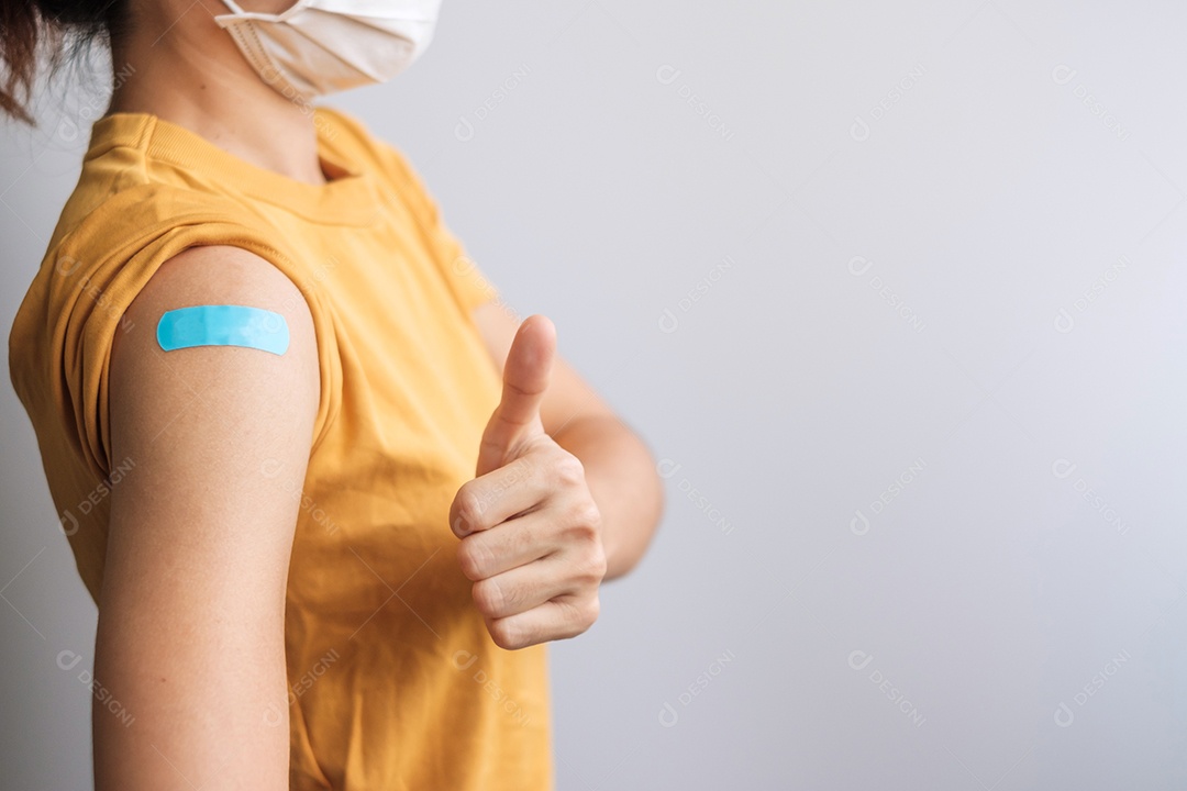 mulher mostrando curativo após receber a vacina covid 19. Vacinação