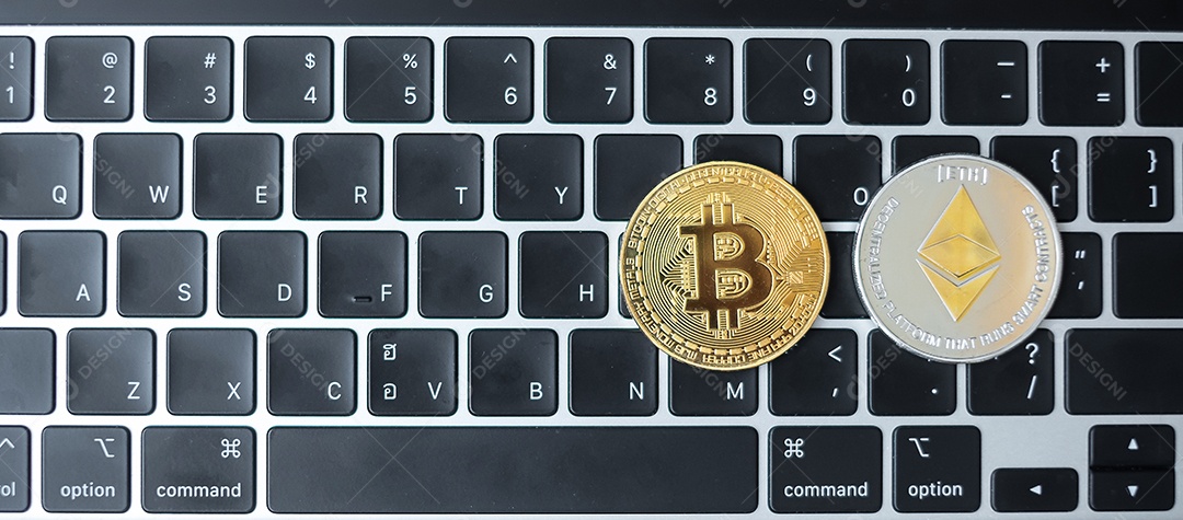 Golden and silver cryptocurrency on keyboard laptop, Bitcoin