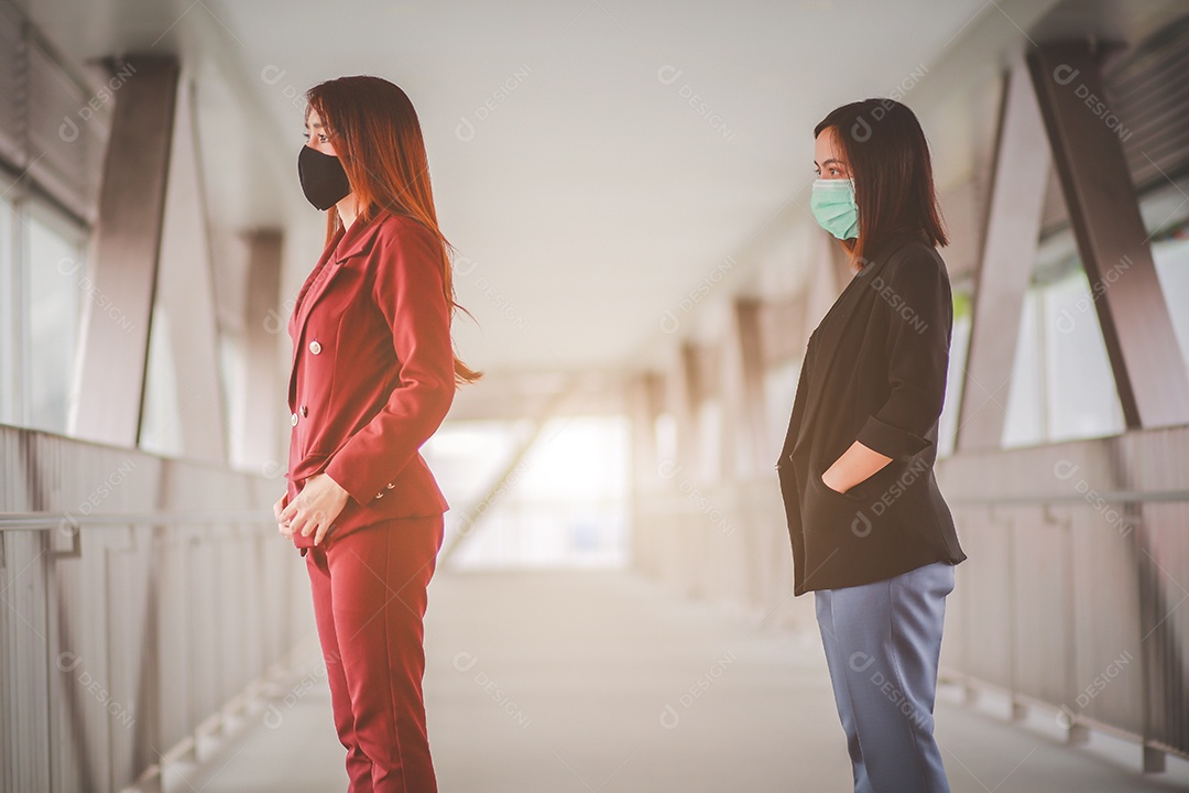 Two Asian women 1 meter distance from other people keep distance protect from COVID-19 virus and people social distancing for infection risk.