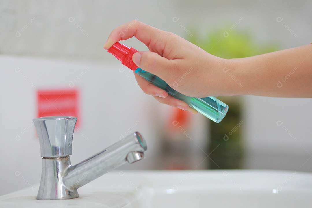 Woman's hand is spraying alcohol, disinfectant spray
