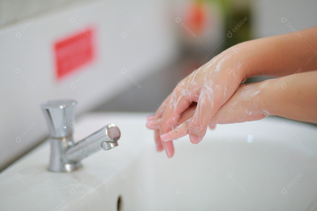Wash your hands with warm water and soap, rubbing your nails and fingers