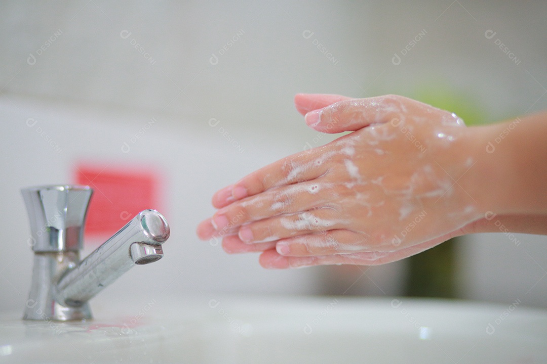 Wash your hands with warm water and soap, rubbing your nails and fingers