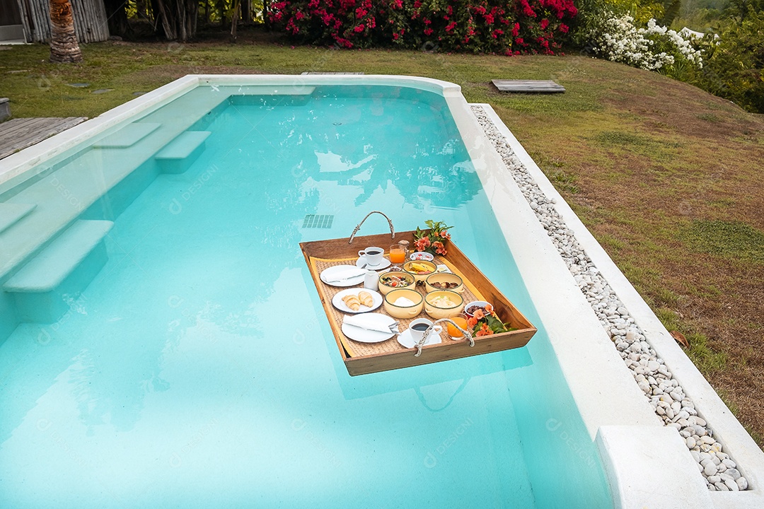 Floating breakfast tray by the pool at luxury hotel