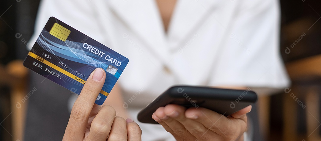Empresária segurando cartão de crédito e usando smartphone