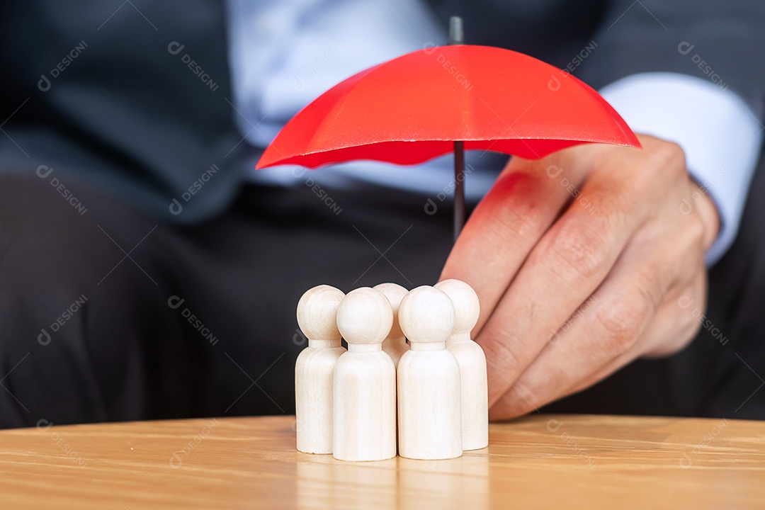 Mão de empresário segurando guarda-chuva e capa de madeira de corvo