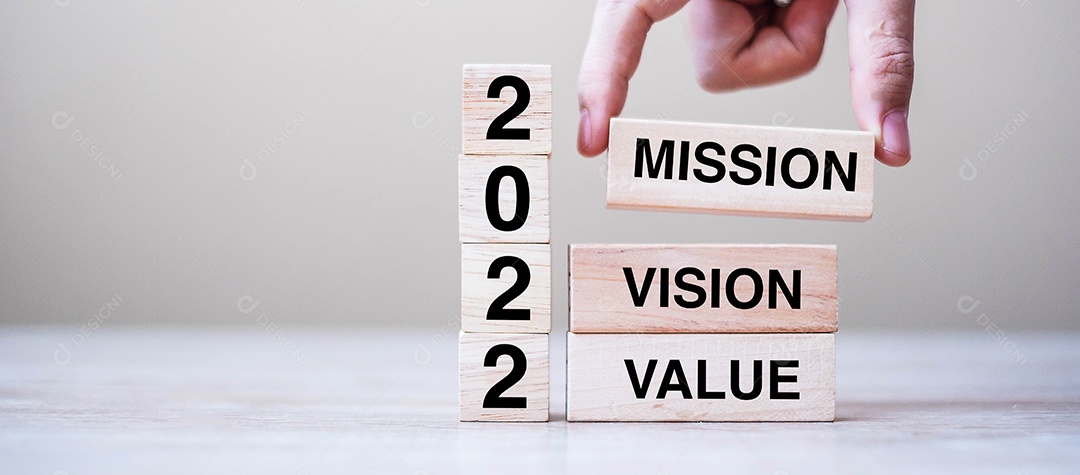 Mão de empresário segurando um cubo de madeira com texto 2022.