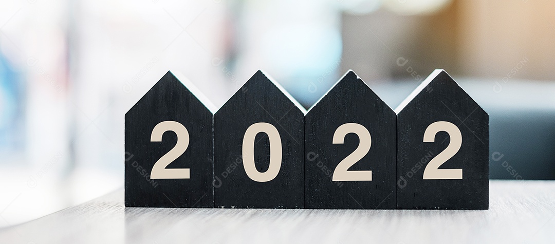 2022 feliz ano novo com modelo de casa de madeira no escritório de mesa. Conceitos de casa nova, financeiro, seguro de propriedade e imobiliário