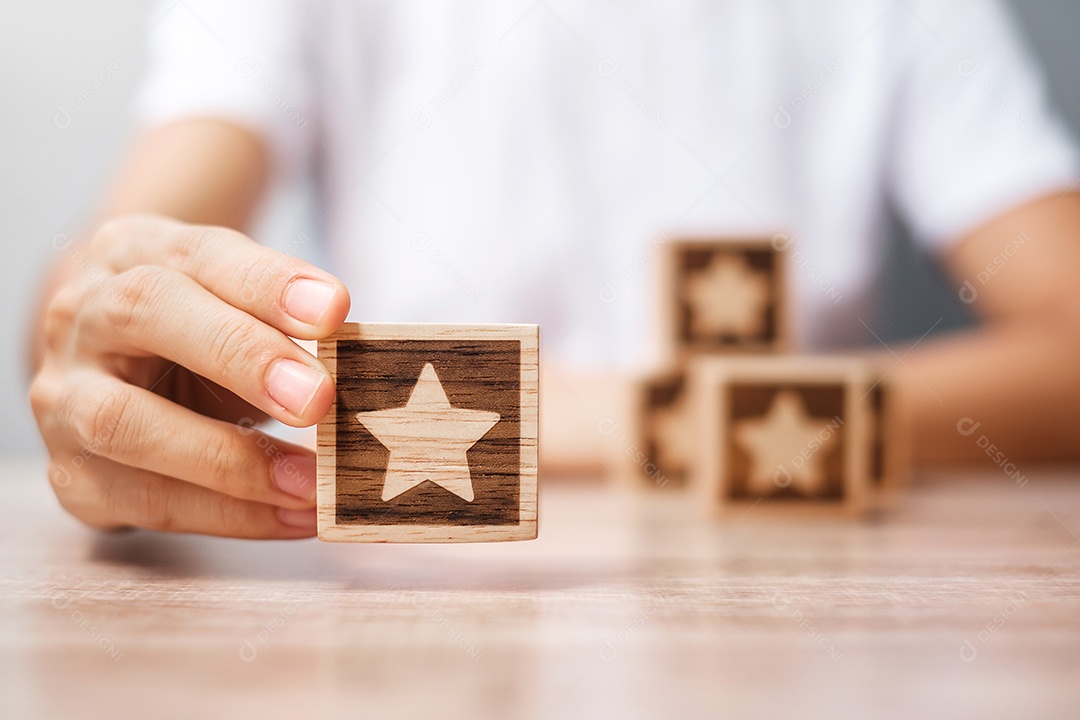 Man hand holding Star Block. Customer chooses rank for user rotation