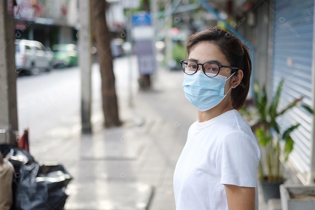 Mulher usando máscara facial médica durante a caminhada na rua