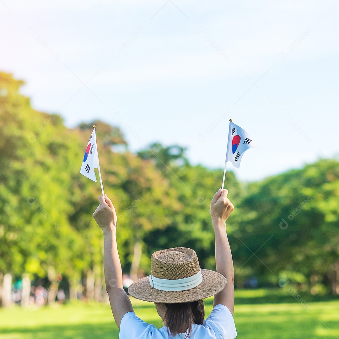 mão segurando a bandeira da Coreia no fundo da natureza. Fundação Nacional