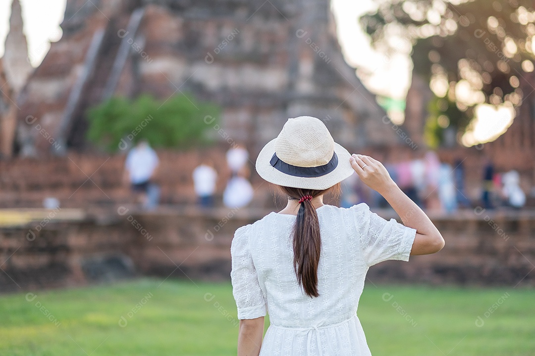 Mulher turista de vestido branco visitando a antiga stupa