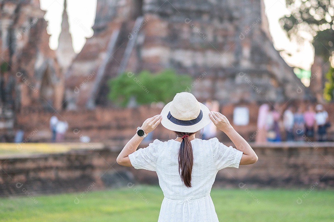 Tourist woman in white dress visiting ancient stupa at Wat Ch