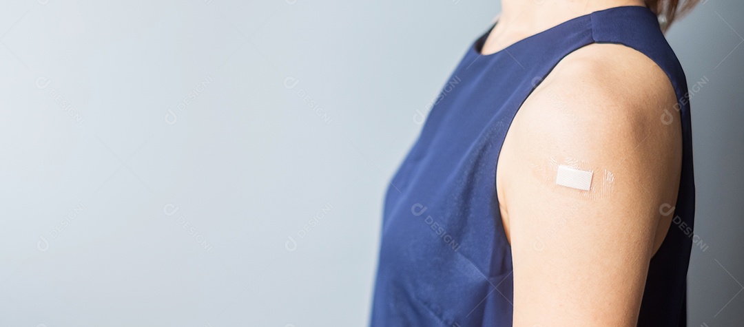 mulher mostrando o braço com curativo após receber covid 19