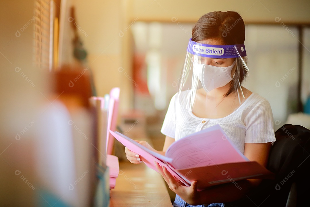 Mulher trabalhadora de escritório usando protetor facial. em quarentena para coronavírus