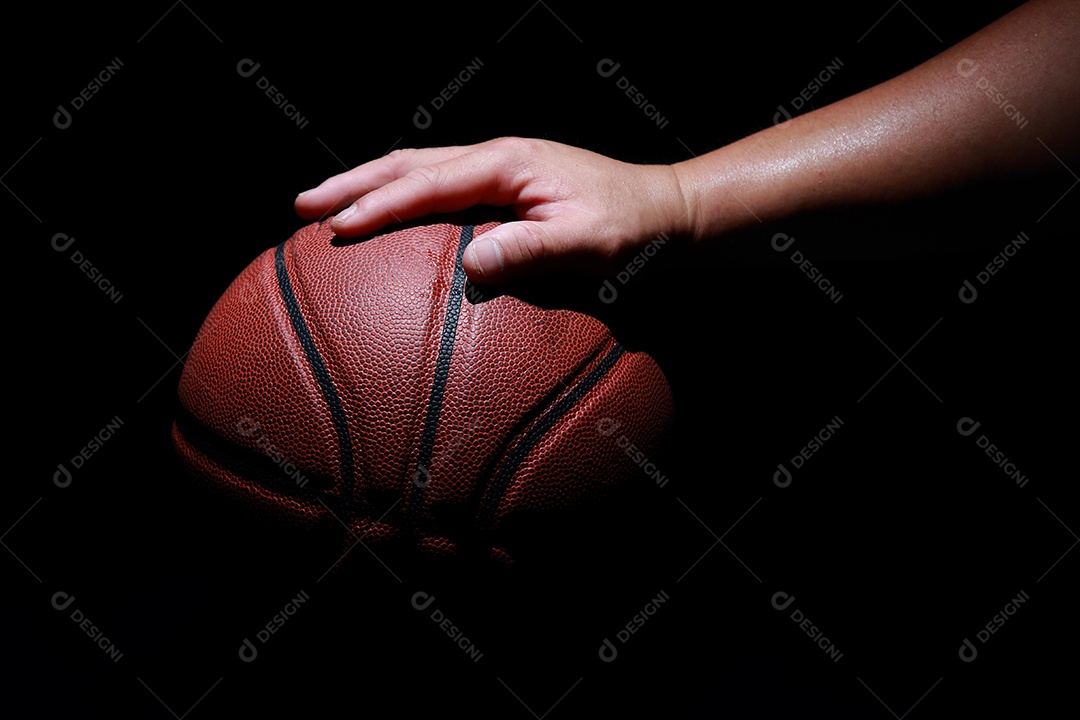 Mãos segurando bolas de basquete no fundo cinza do estúdio. conceito de confronto.