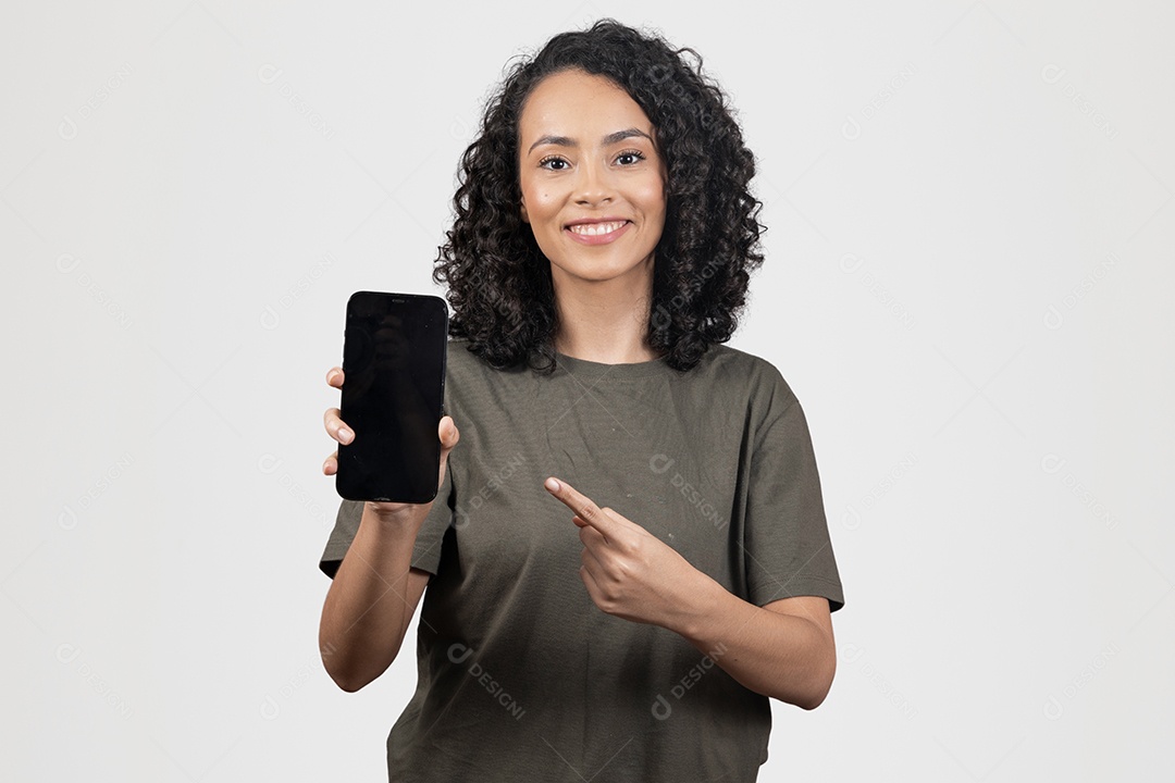 Linda mulher jovem cabelo cacheado sorridente segurando celular smartphone sobre fundo branco