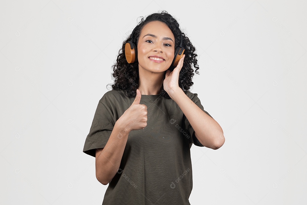 Linda mulher jovem usando fones de ouvido vermelho branco cabelo cacheado sorridente sobre fundo branco