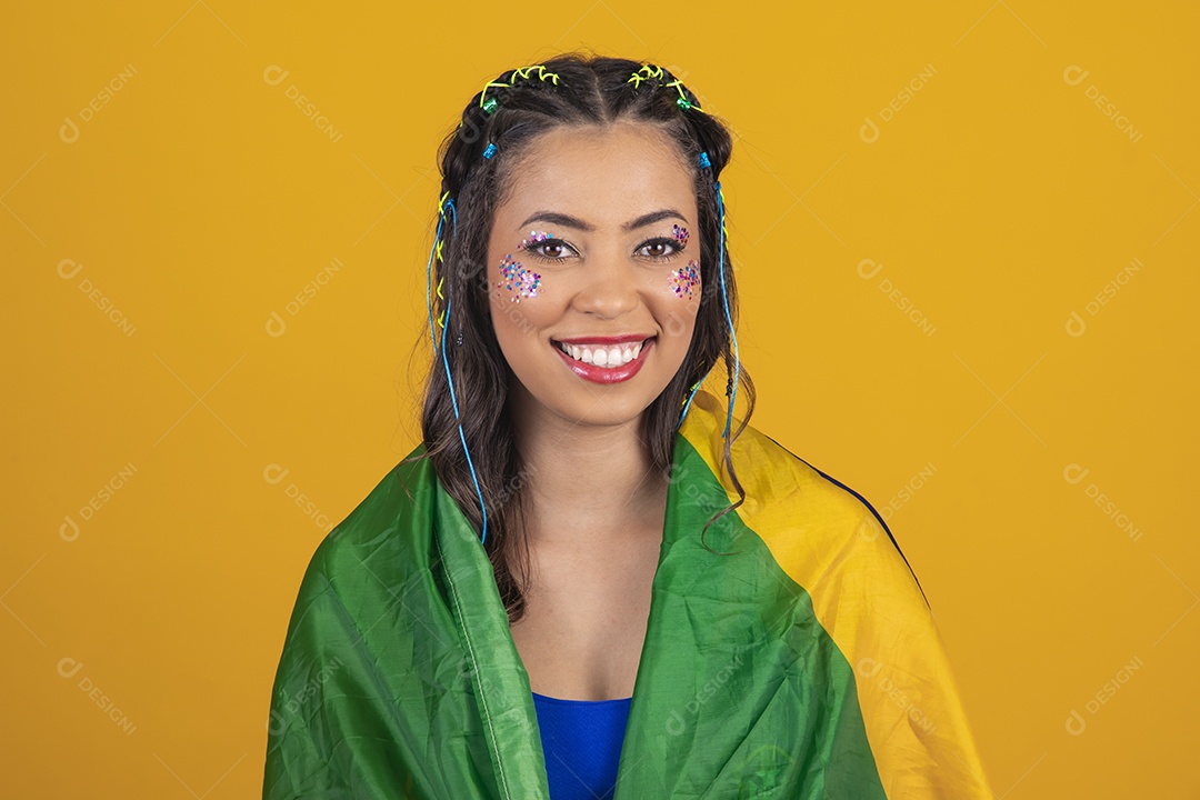 Linda mulher jovem com a bandeira do brasil nas suas costas sobre fundo amarelo