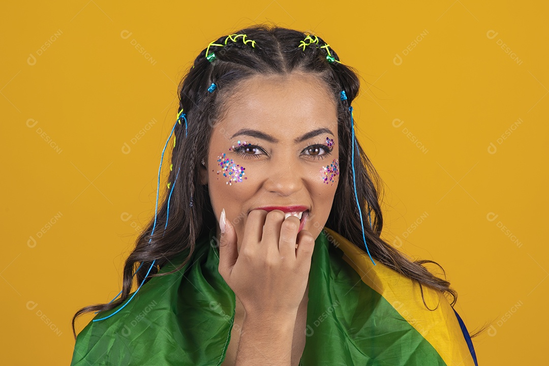 Linda mulher jovem com a bandeira do brasil nas suas costas sobre fundo amarelo