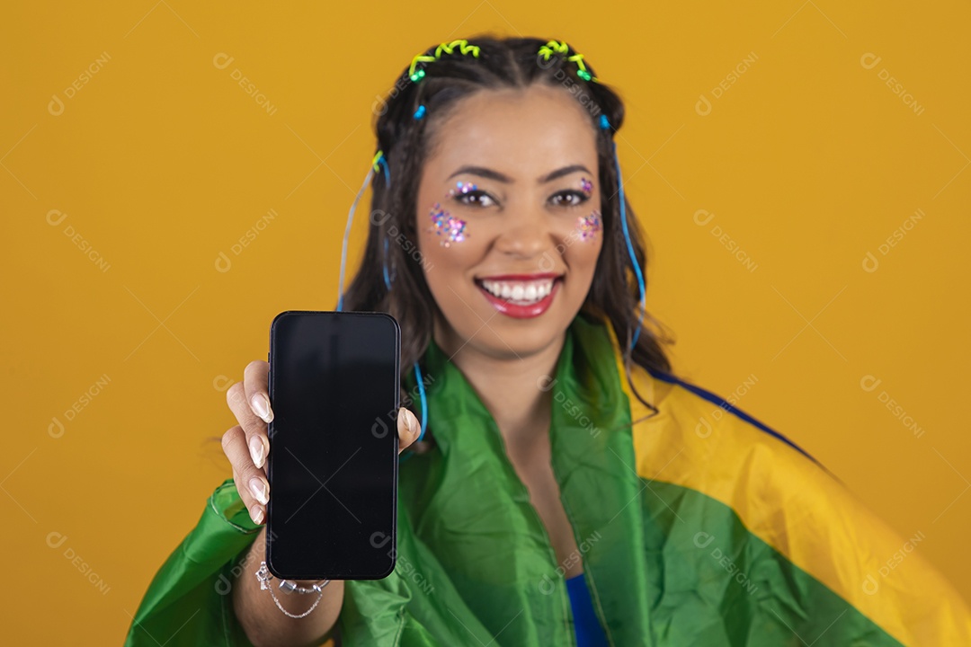 Linda mulher jovem com a bandeira do brasil nas suas costas sobre fundo amarelo