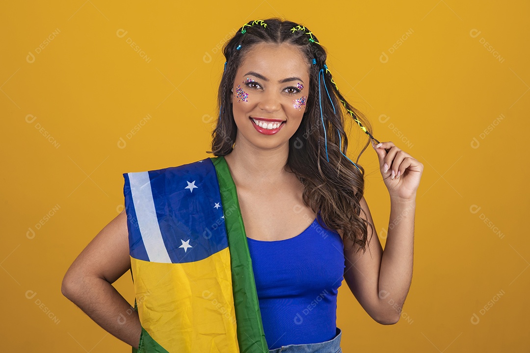 Linda mulher jovem com a bandeira do brasil nas suas costas sobre fundo amarelo