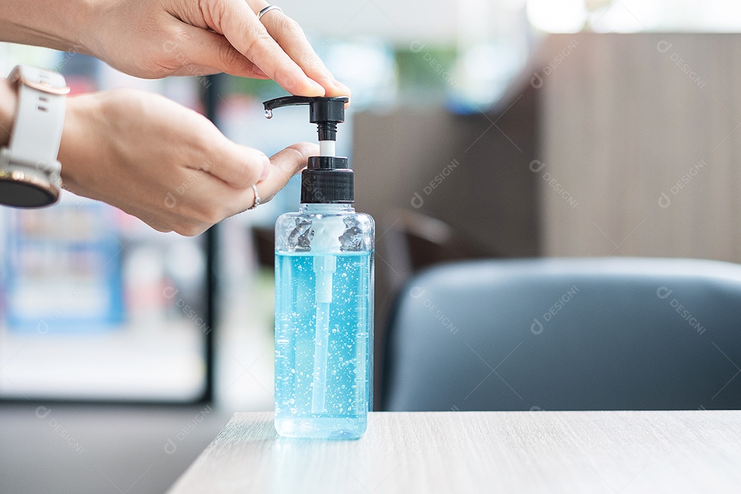 Woman's hands using hand sanitizer gel dispenser, against corona virus