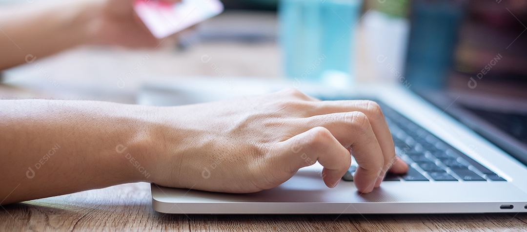 woman holding credit card and using laptop for online shopping