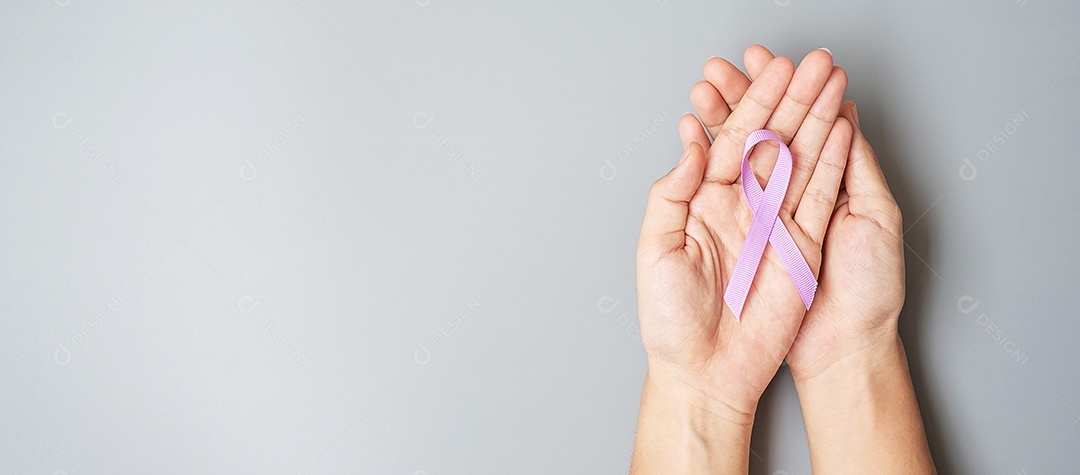 World Cancer Day (February 4). Woman hand hoy purple lavender ribbon to support people living and illness. Health care and medical concept