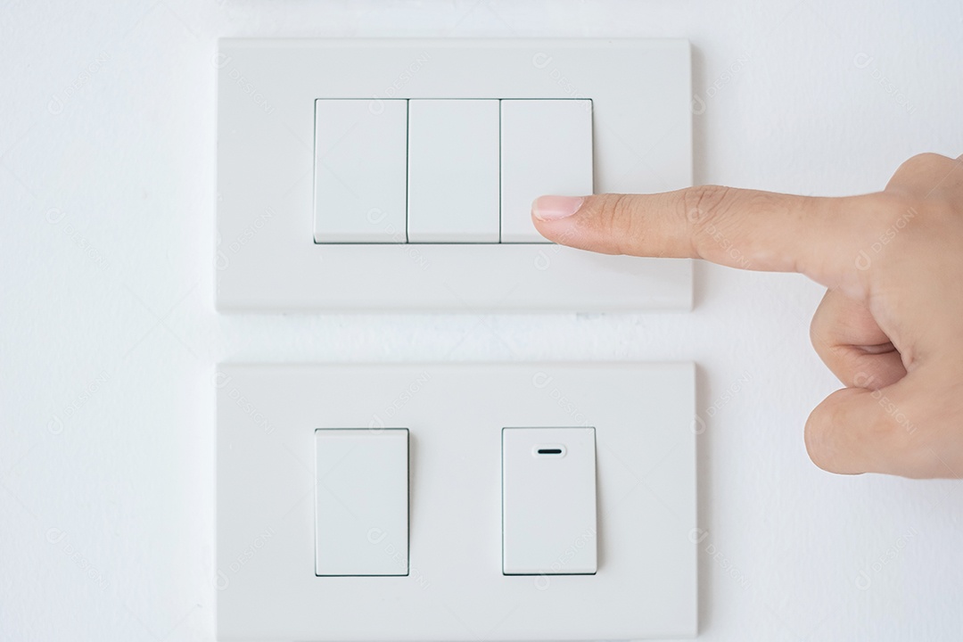 Close-up male finger is turned on or off on light switch on white wall at home. Energy, Energy, Electricity and Lifestyle Saving Concepts