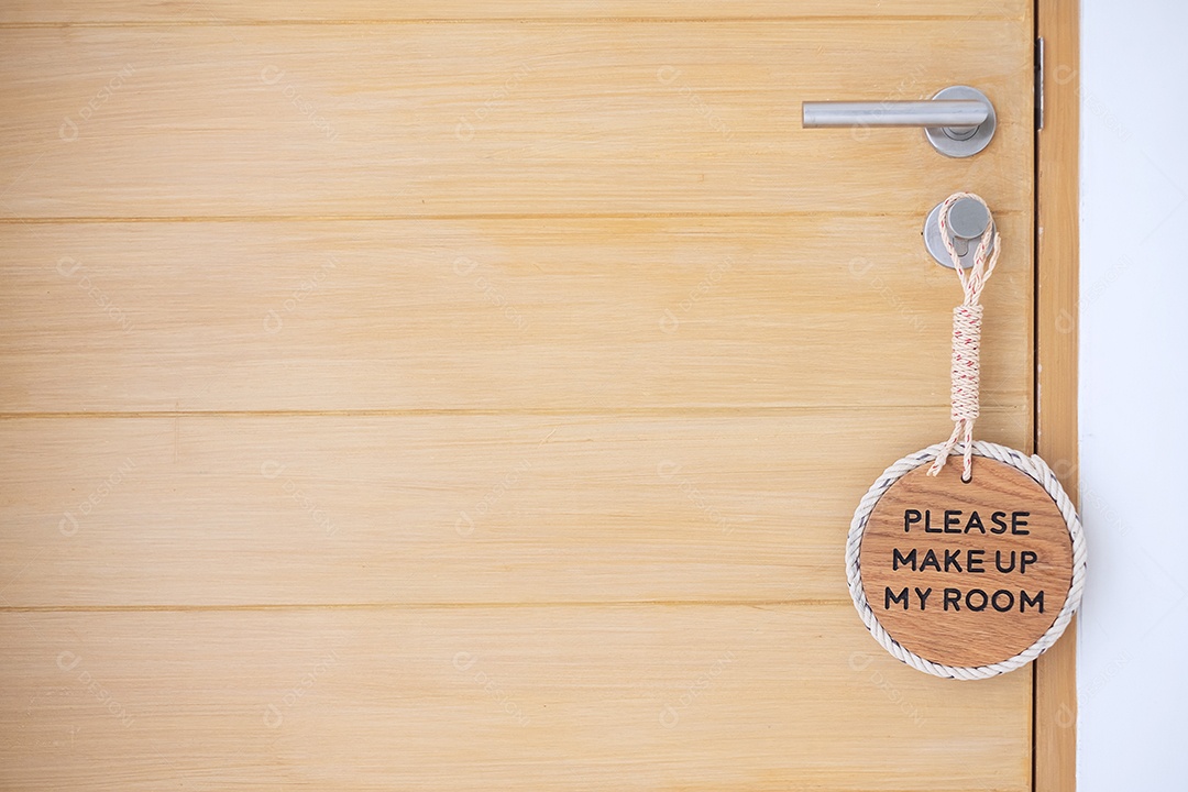 Closing sign PLEASE COMPOST MY ROOM hanging near wooden door in luxury hotel