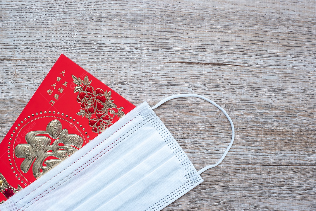 Envelope vermelho ou Ang pao e máscara facial médica contra infecção por doença de Coronavirus. O caractere chinês significa felicidade ou boa sorte, e a frase chinesa significa sorte e riqueza. Ano Novo Lunar