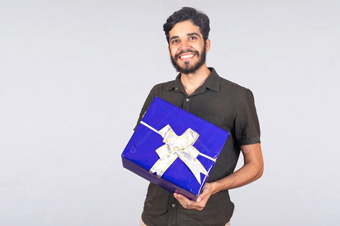 Homem jovem barbudo segurando caixa de presente sobre fundo isolado branco