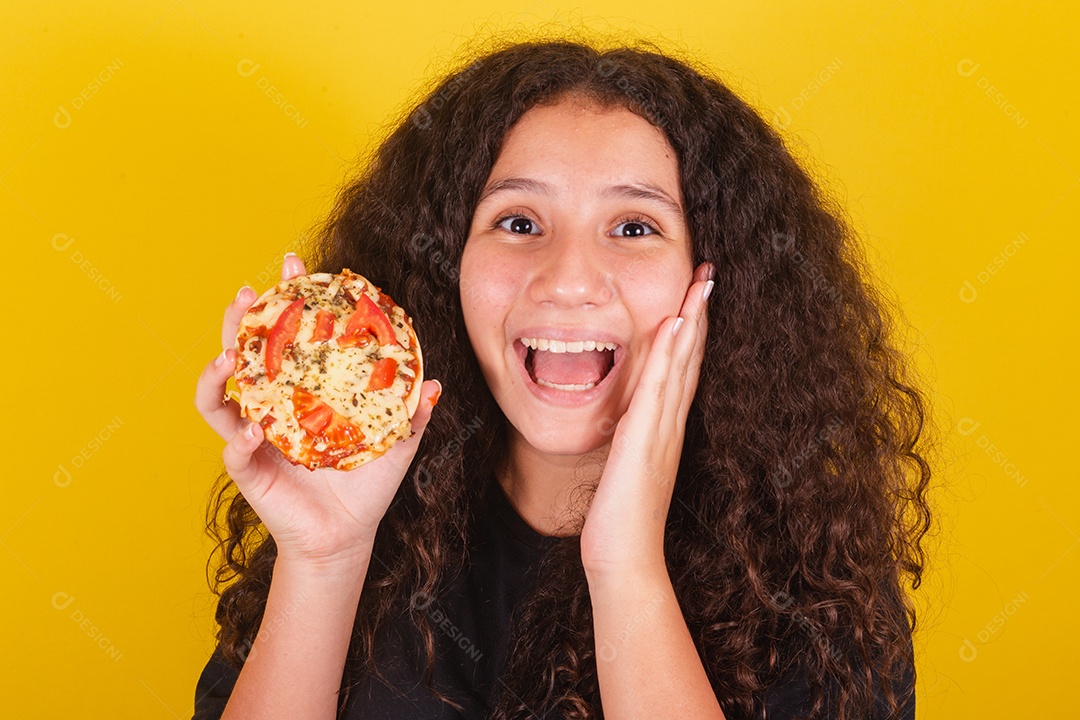 Linda mulher jovem garota segurando mini pizza sobre fundo isolado amarelo