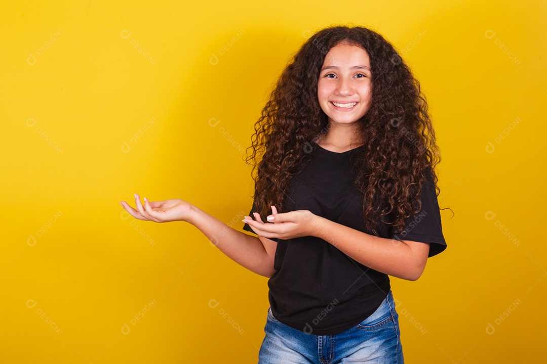 Linda mulher cabelo cacheado jovem sobre fundo isolado amarelo