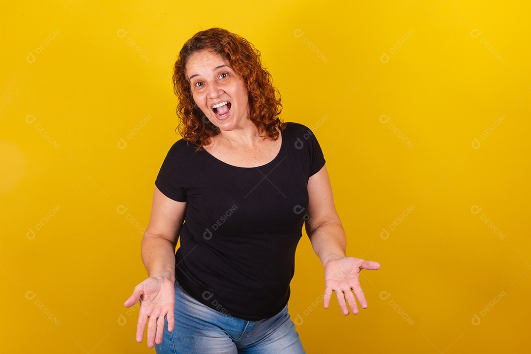 Beautiful smiling young woman over yellow isolated background