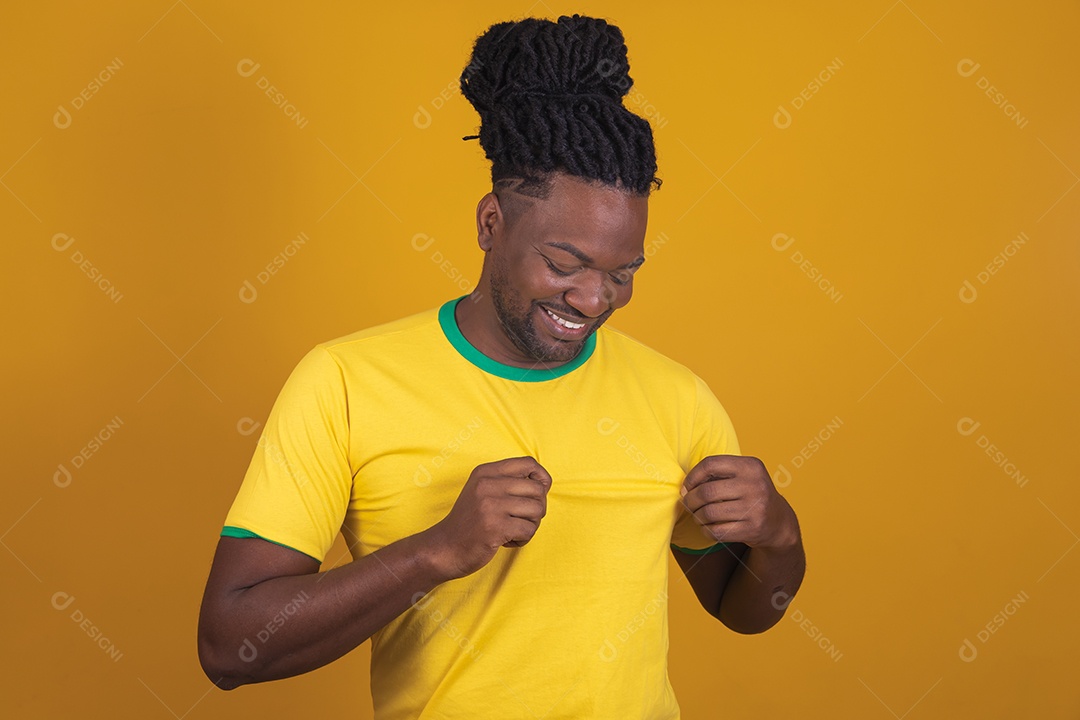 Homem brasileiro vestindo uma camiseta do Brasil fazendo gestos