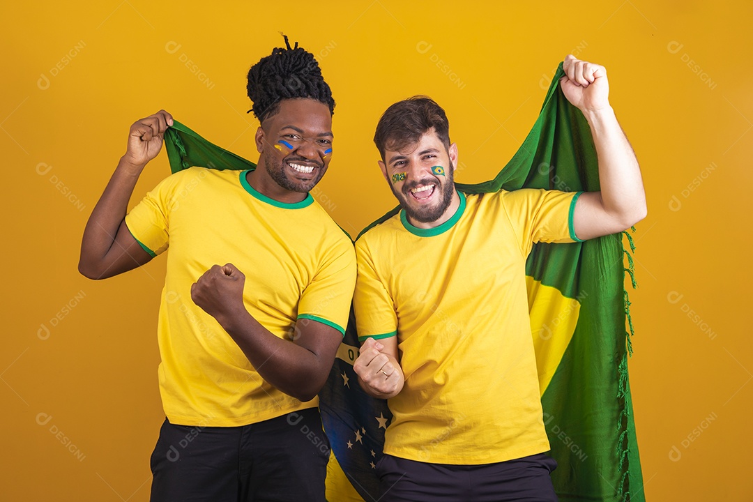 Homens brasileiros vestidos com camisetas do Brasil segurando acessórios de torcidas