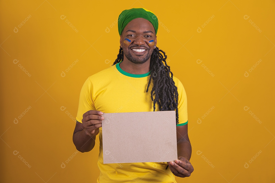 Brazilian man wearing a Brazil t-shirt holding a blank paper