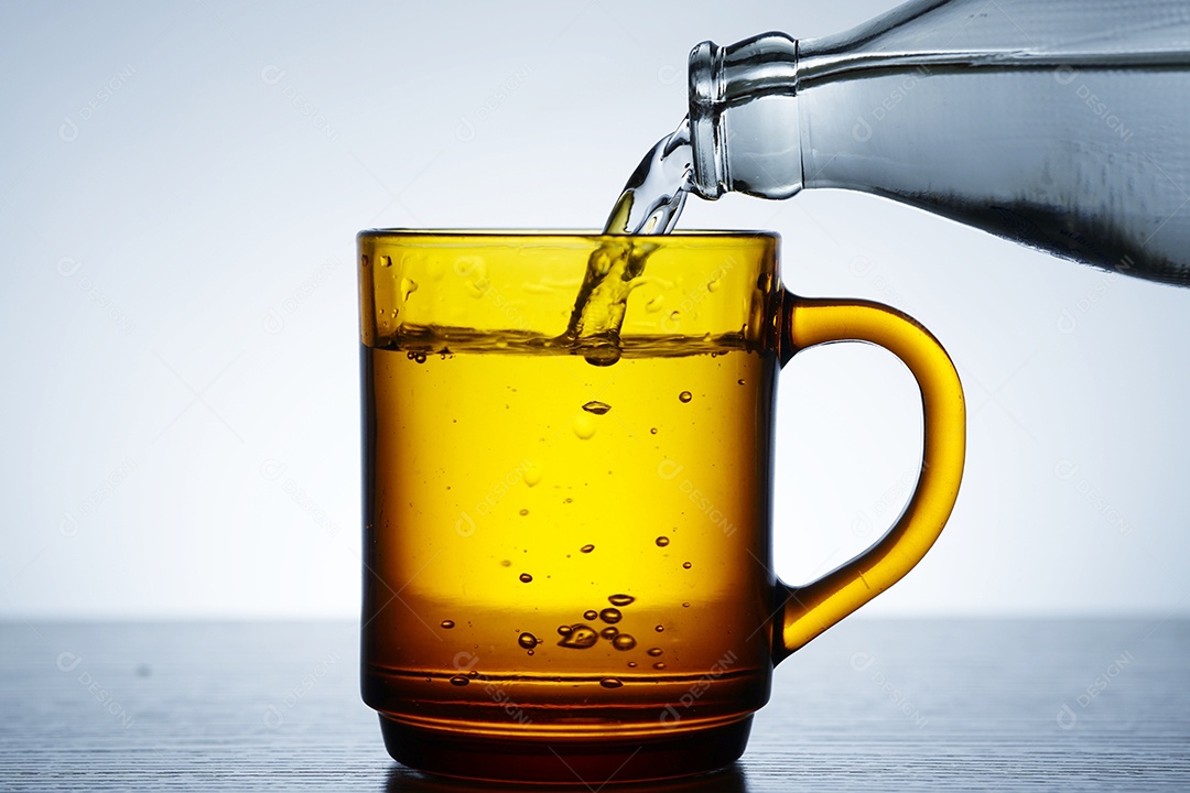 Bottle putting water in a cup