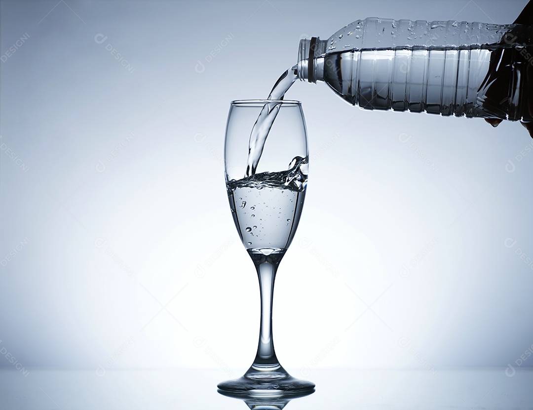 Mão segurando garrafa colocando água em uma taça.