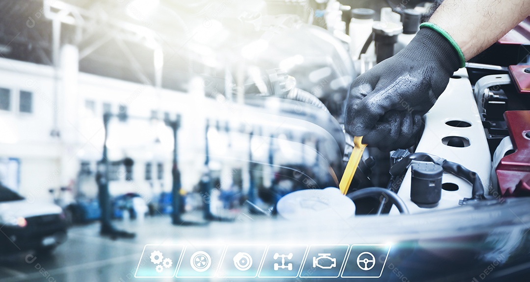 A mão do mecânico está puxando a vareta de óleo e a oficina de reparação de automóveis