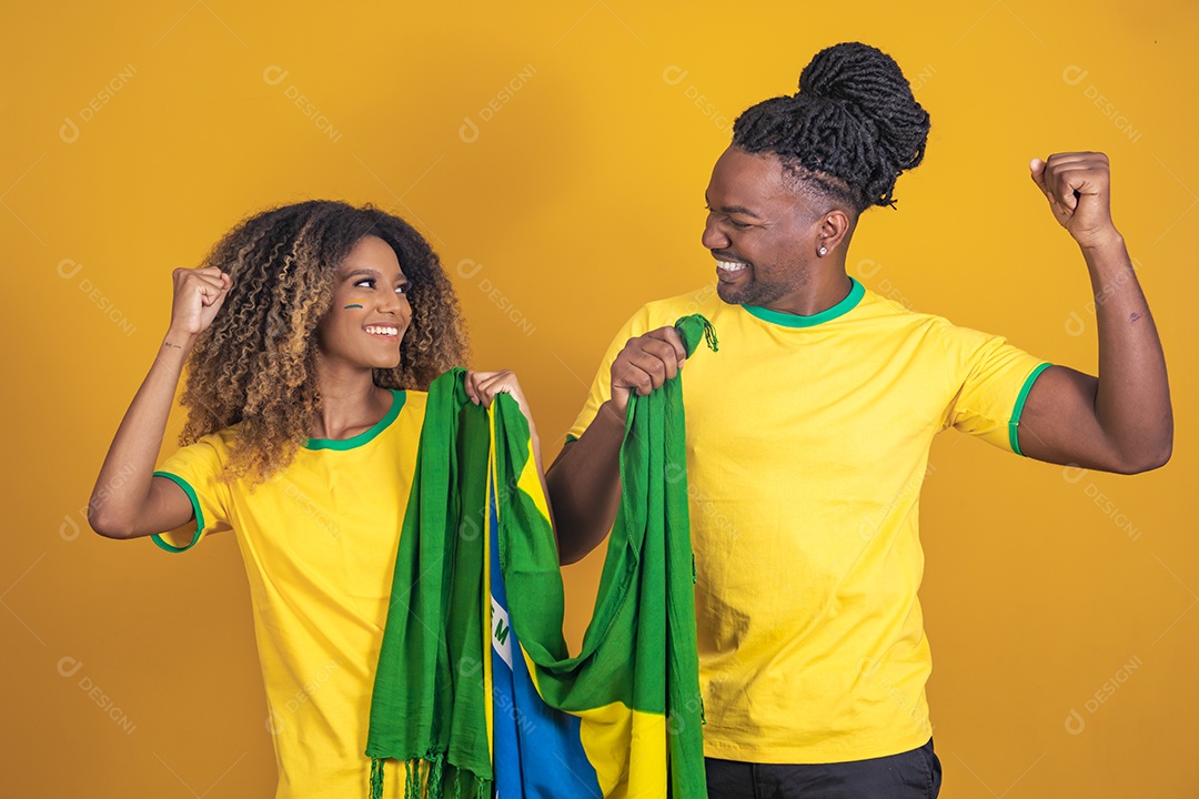 Casal afro-brasileiro segurando a bandeira do Brasil