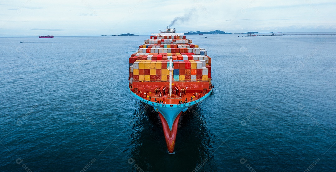 Aerial view in front of cargo ship carrying container and rushing to export goods from cargo yard port for ship custom shipping concept.