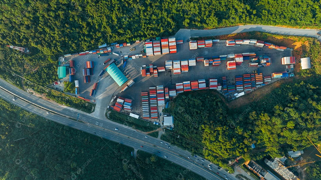 The freight container yard next to the road and surrounded by mountains
