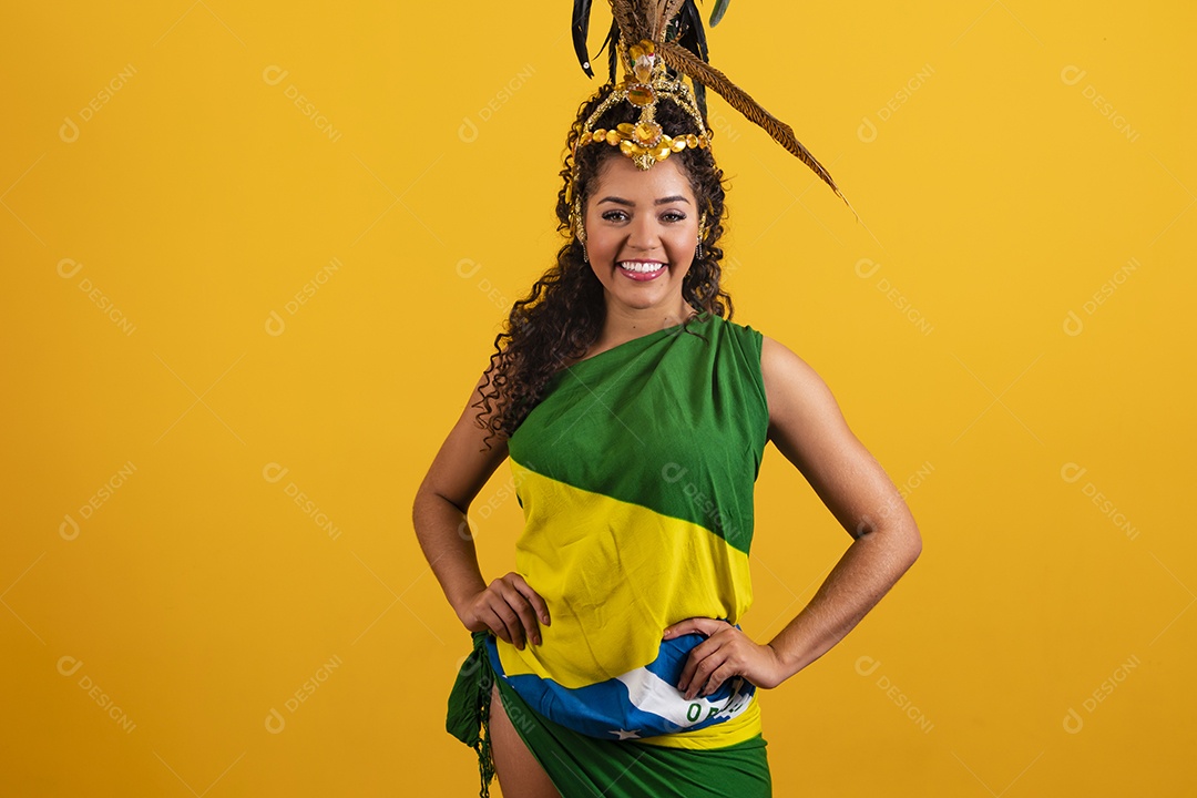 Beautiful young brunette woman supporting Brazil wearing a carnival costume and the flag of Brazil on the coast
