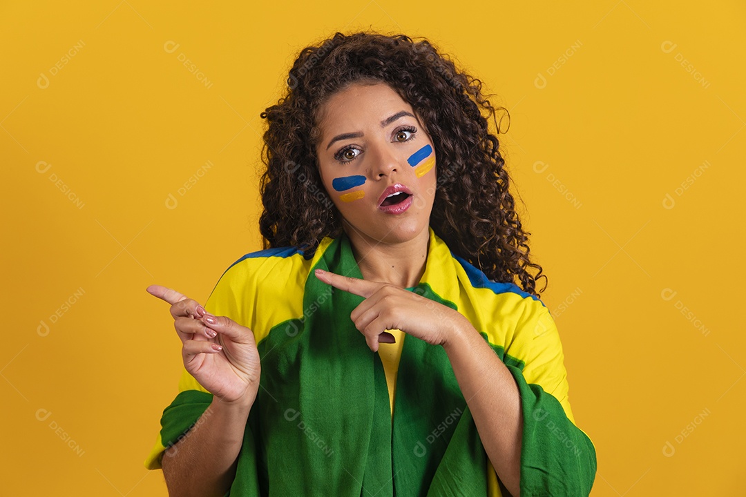 Linda mulher jovem morena segurando bandeira do brasil cabelo afro sobre fundo isolado amarelo